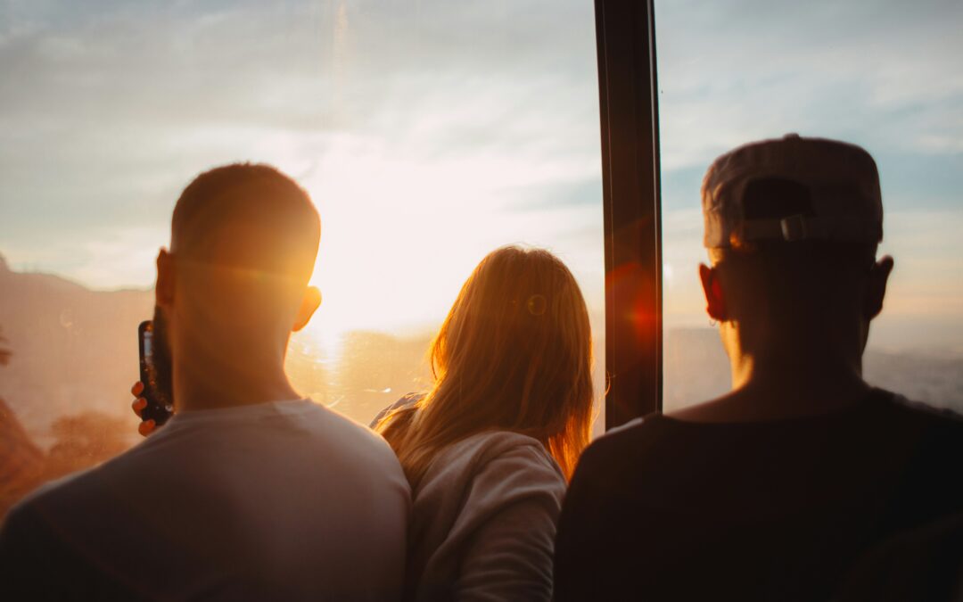 three people standing each other during golden time